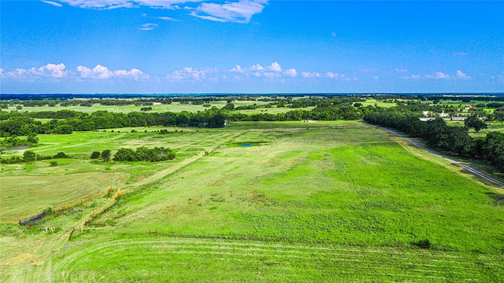 2215 Denver Road Sunset, TX 76270 - Photo 4 of 36 a view of a golf course with a big yard