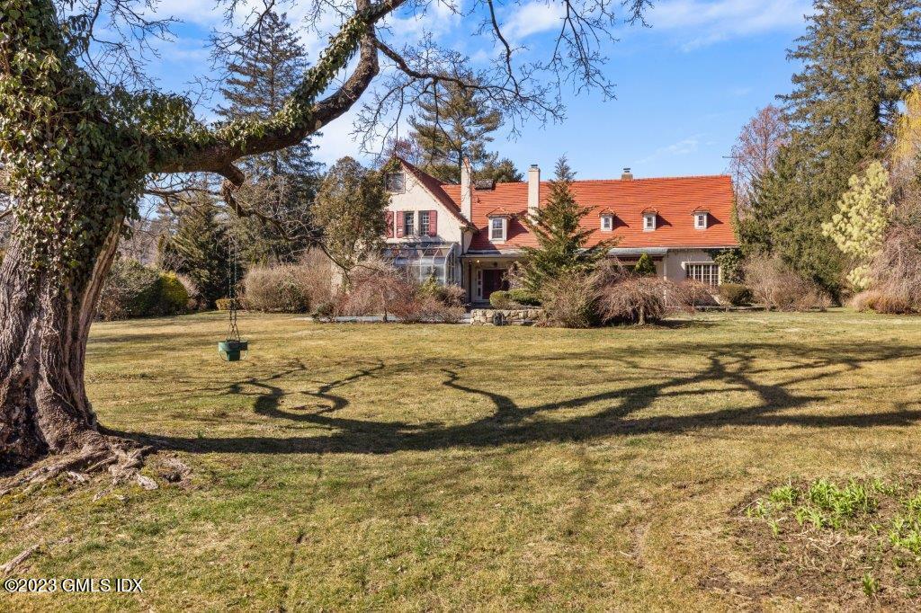 a view of a yard with large trees