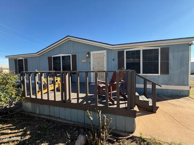 a front view of a house with outdoor seating