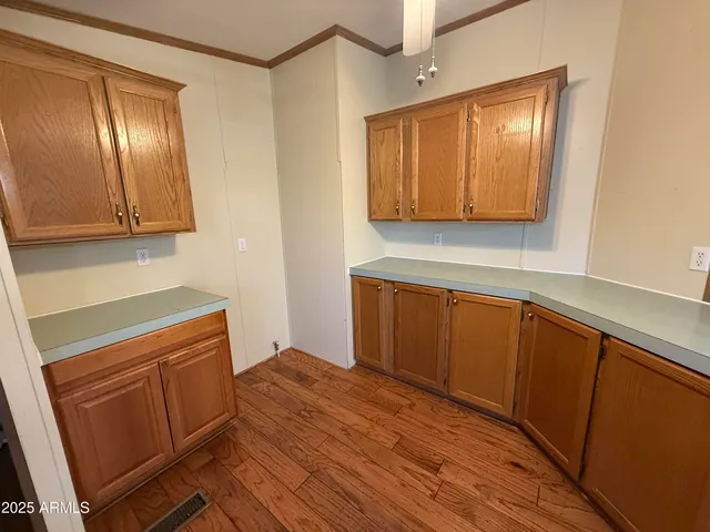 a kitchen with wooden cabinets and a sink