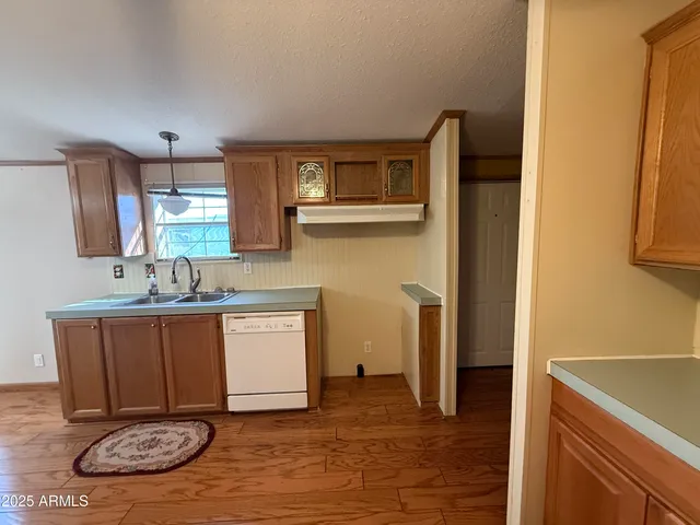 a view of a kitchen with a sink and a refrigerator