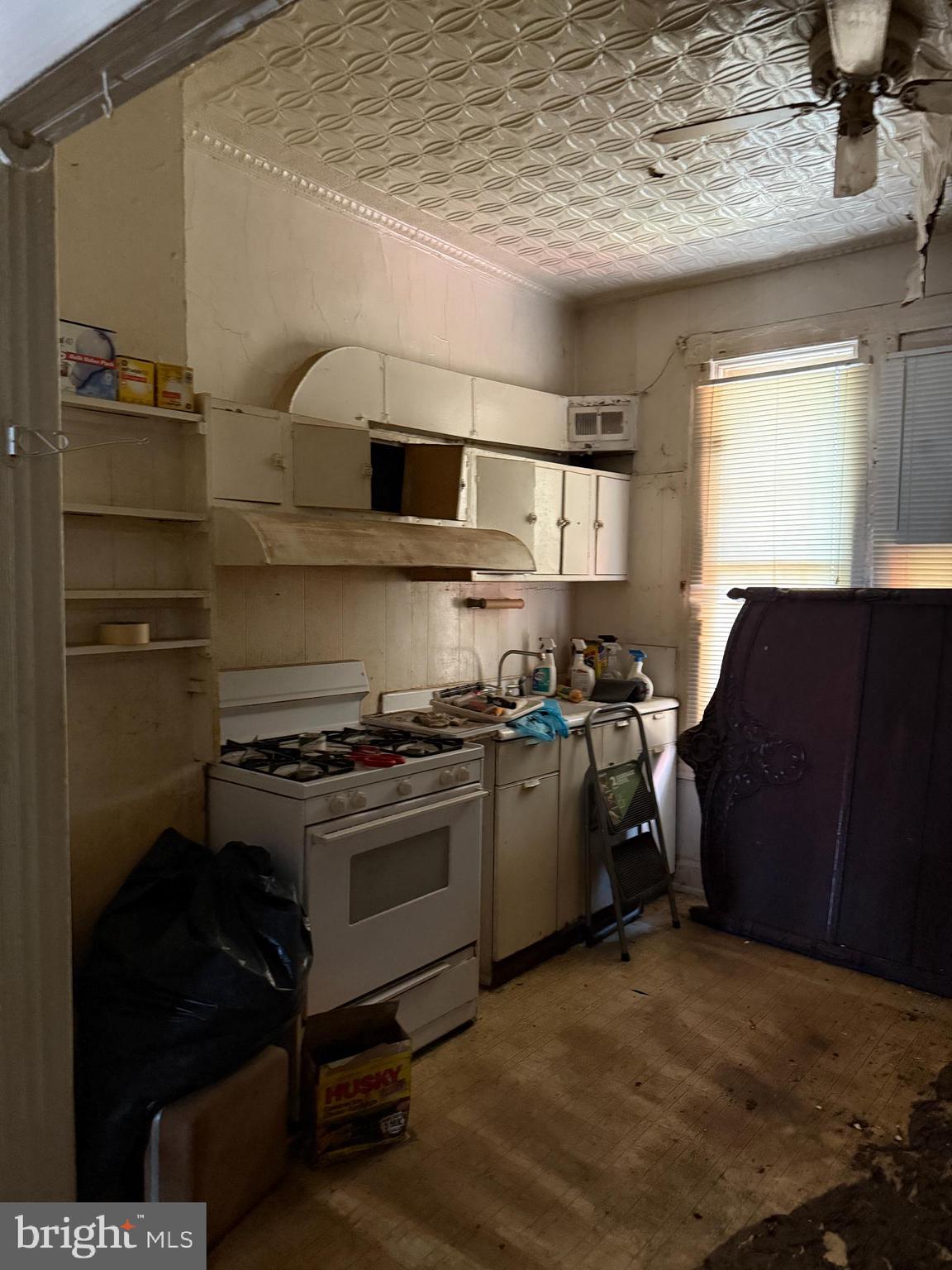 4919 Eastern Avenue Baltimore, MD 21224 - Photo 9 of 17 a kitchen with a stove and a refrigerator