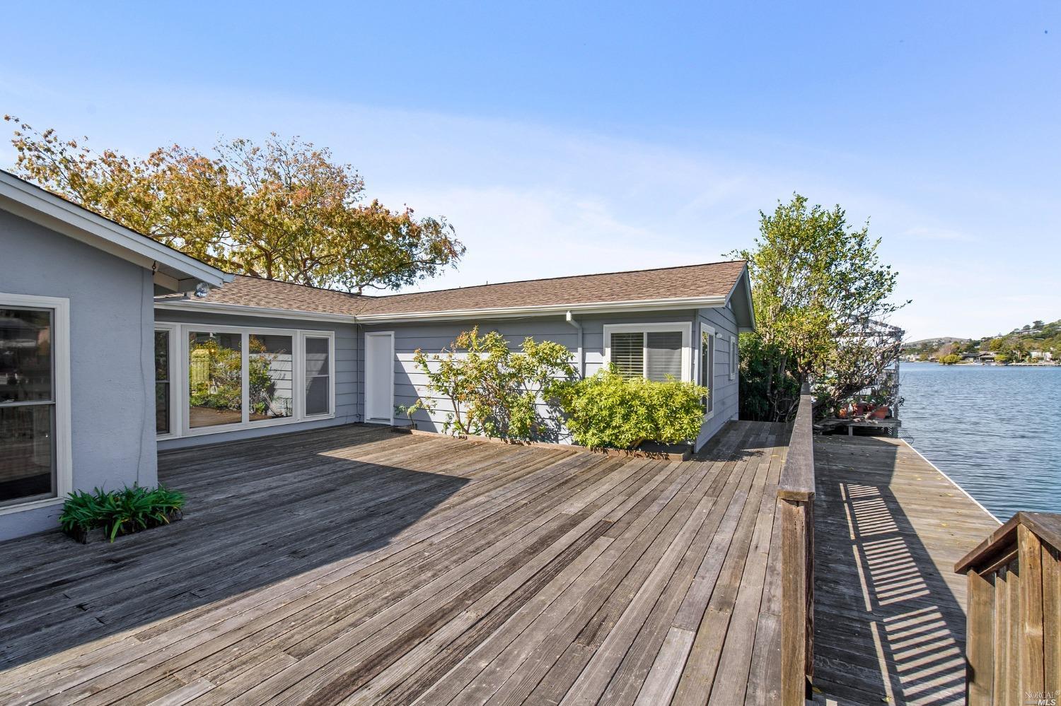 a house with wooden floor in front of it