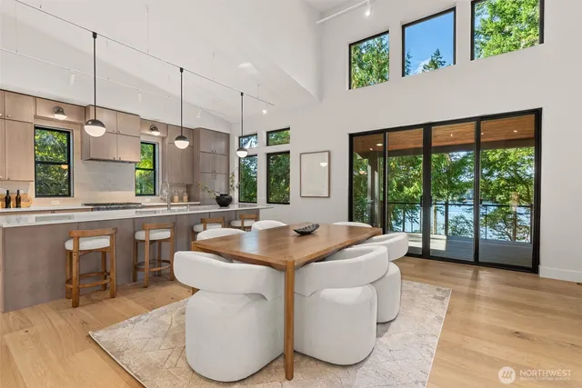 a room with table chairs and a view of living room