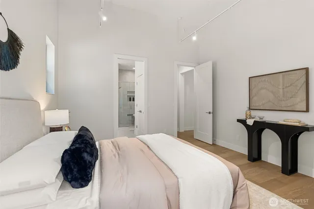 a bedroom with a bed and a painting on the wall