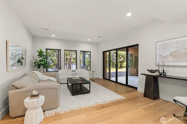 a living room with furniture a flat screen tv and a large window
