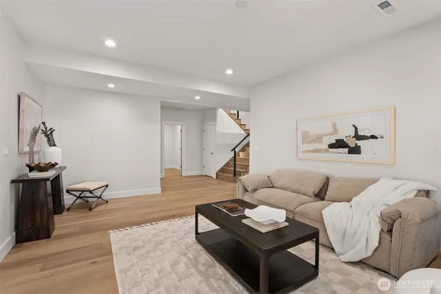 a living room with furniture rug and wooden floor