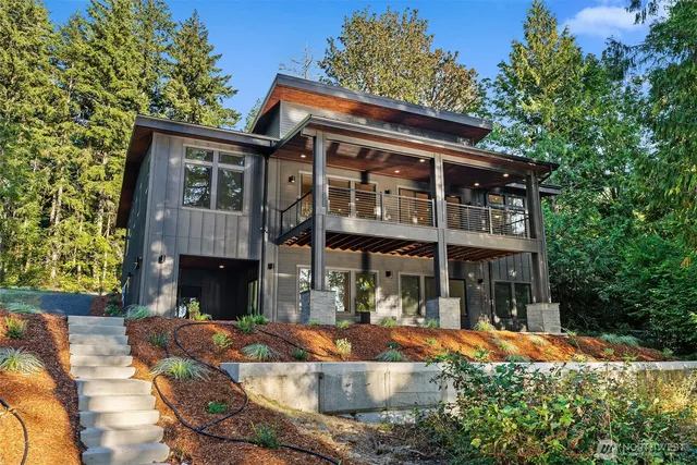 a front view of house with yard and trees around