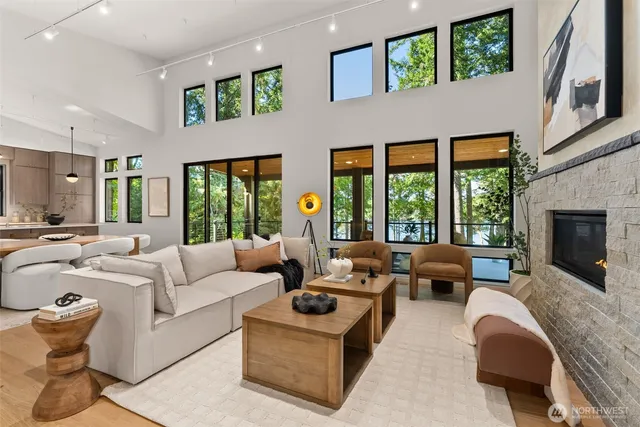 a living room with furniture large window and fireplace