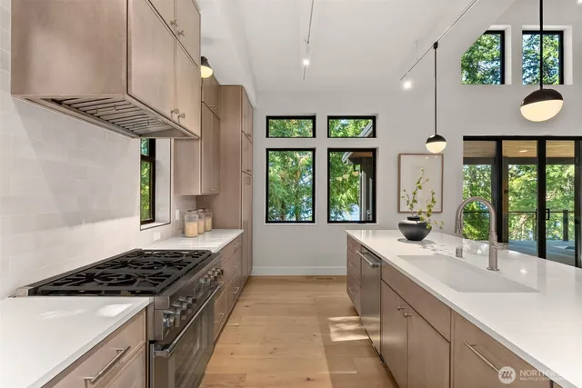 a kitchen with a sink and a stove top oven