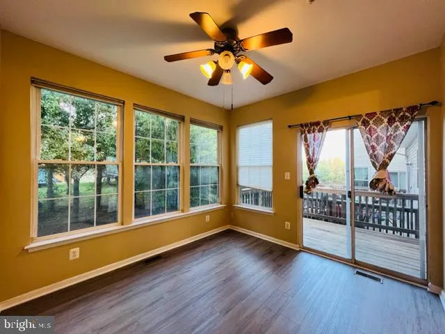 a view of room with window and hardwood floor