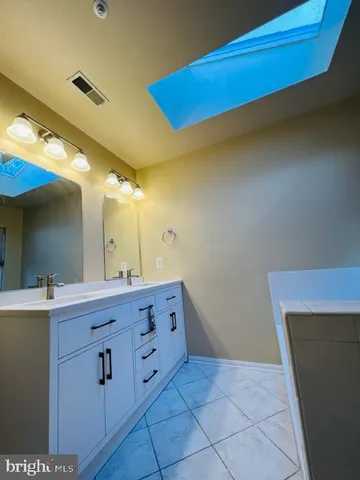 a bathroom with a sink a vanity and a mirror