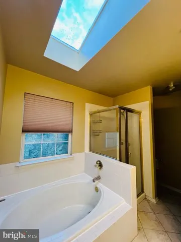 a bathroom with a bathtub and shower