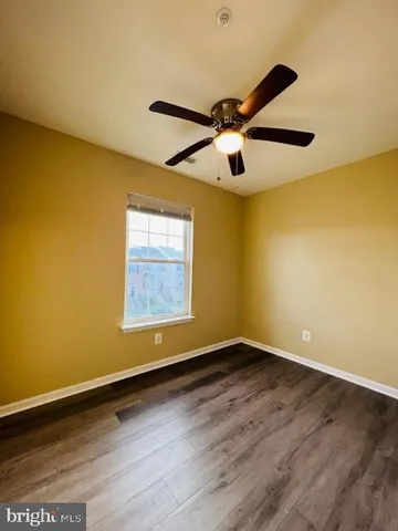 a view of an empty room and wooden floor