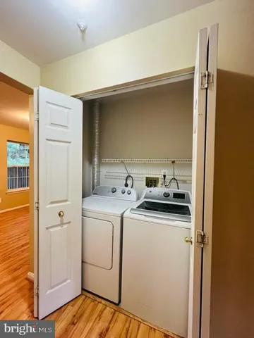 a view of a storage and utility room with washer and dryer