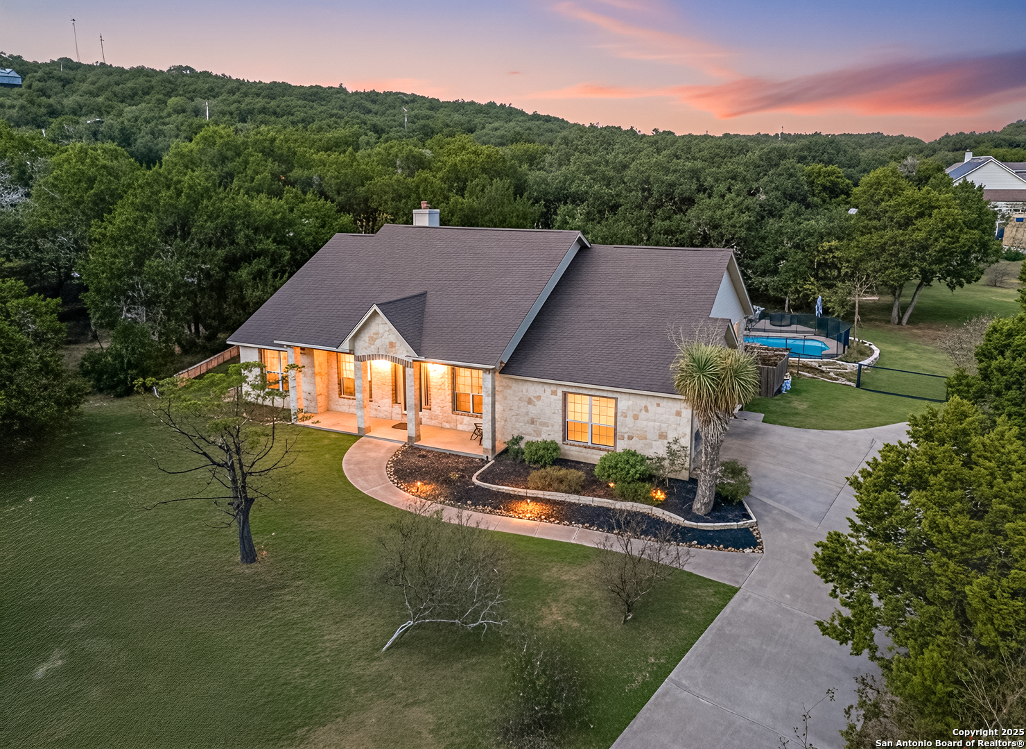 an aerial view of a house with pool lake view and mountain view
