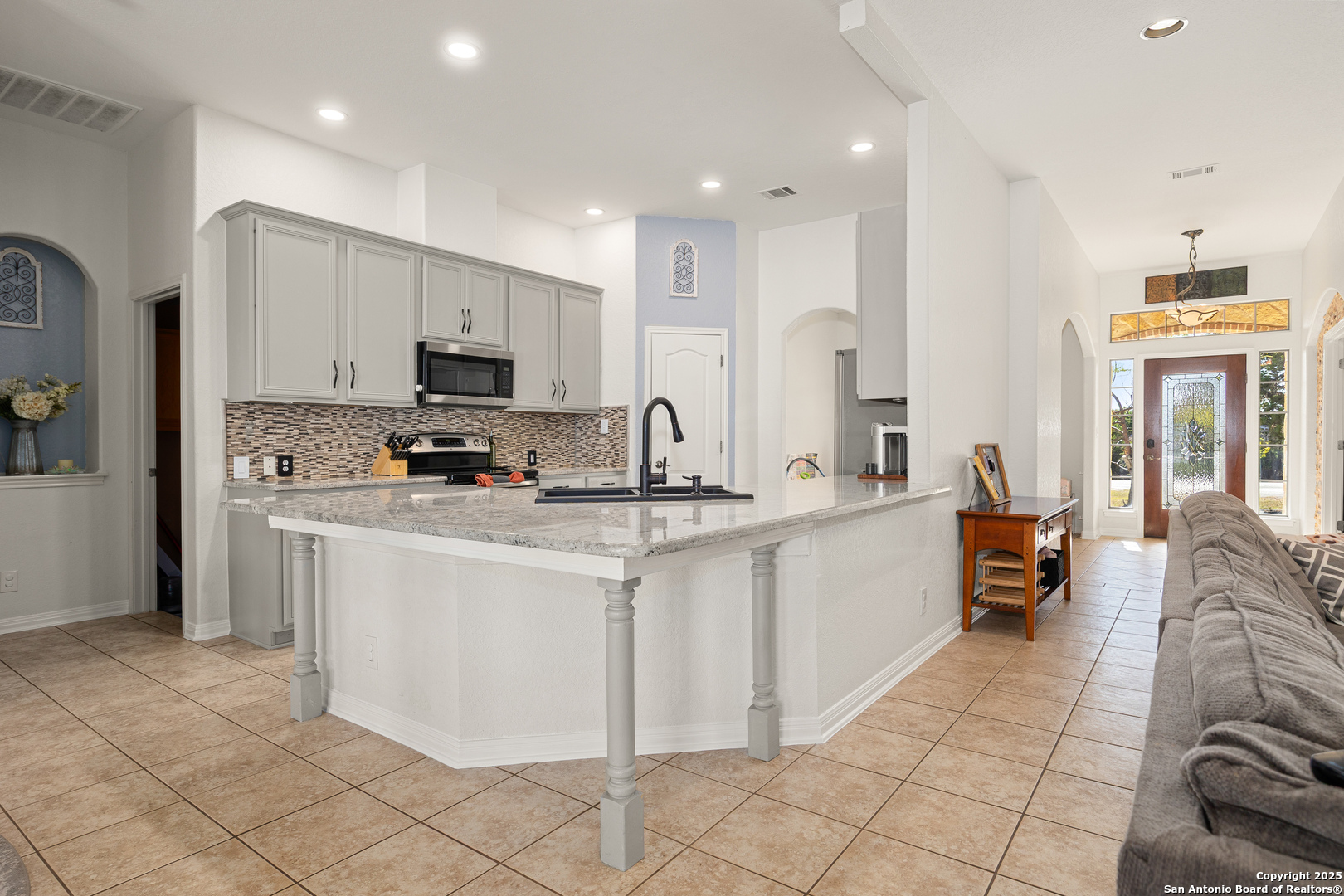 166 Bridle Path Spring Branch, TX 78070 - Photo 13 of 48 a large kitchen with stainless steel appliances kitchen island granite countertop a sink and a stove top oven