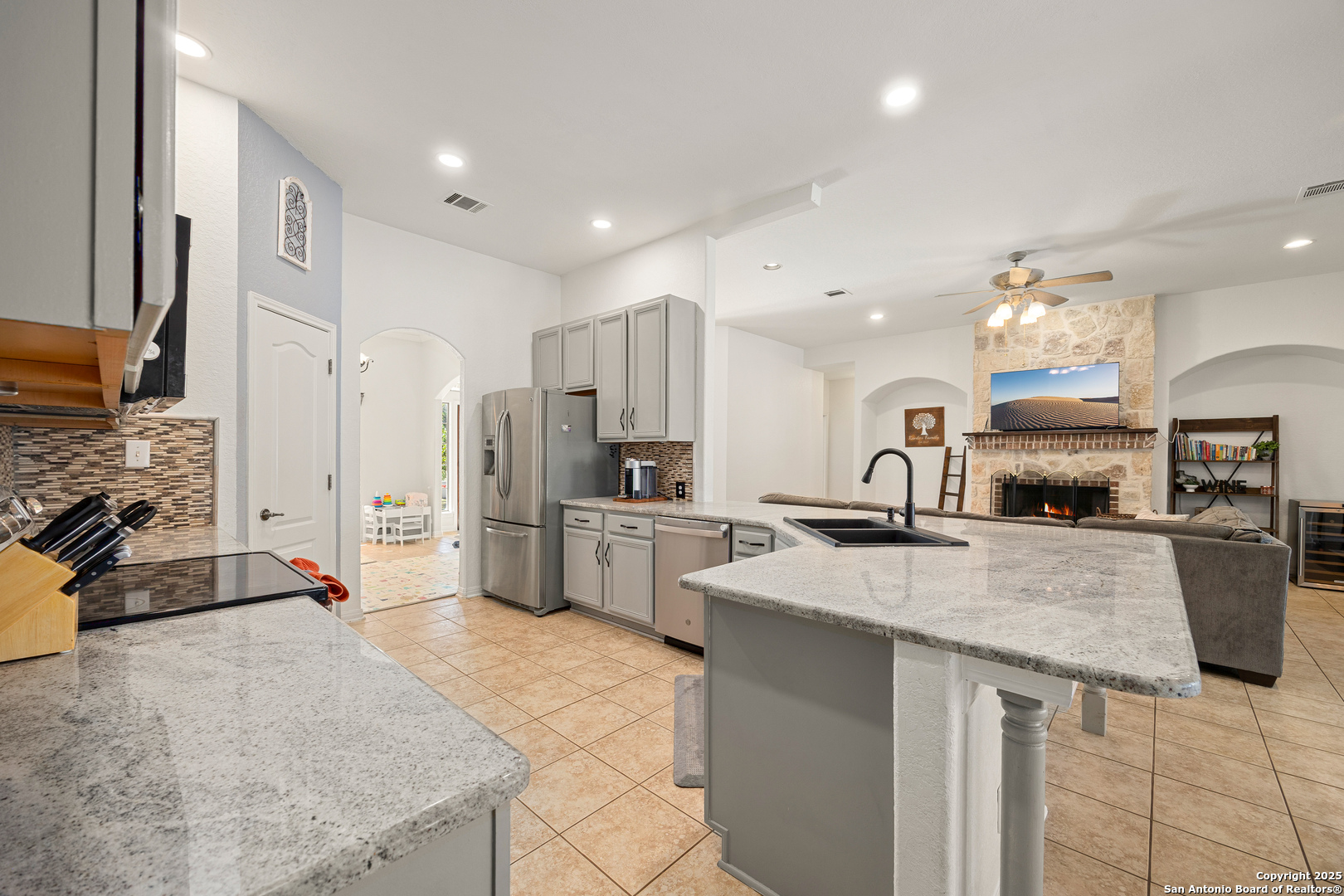 166 Bridle Path Spring Branch, TX 78070 - Photo 14 of 48 a kitchen with stainless steel appliances granite countertop a sink refrigerator and cabinets
