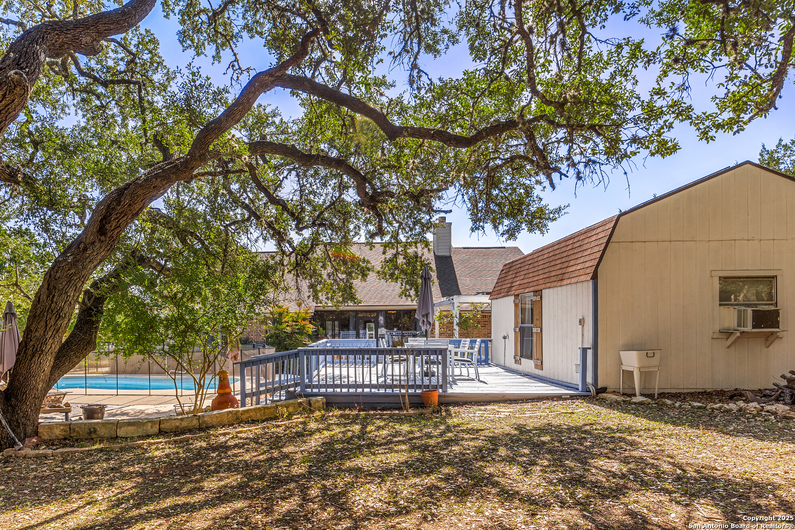 166 Bridle Path Spring Branch, TX 78070 - Photo 32 of 48 a view of a house with a tree and wooden fence