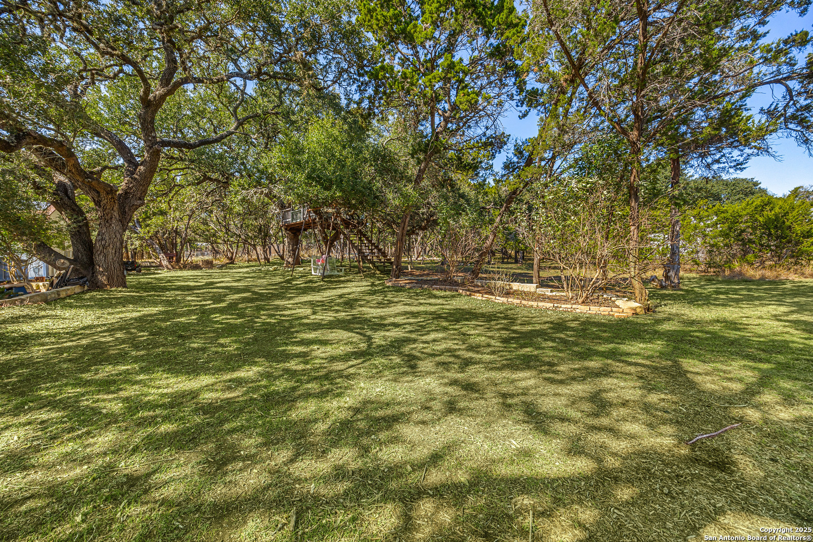 166 Bridle Path Spring Branch, TX 78070 - Photo 36 of 48 a large room with trees in the background