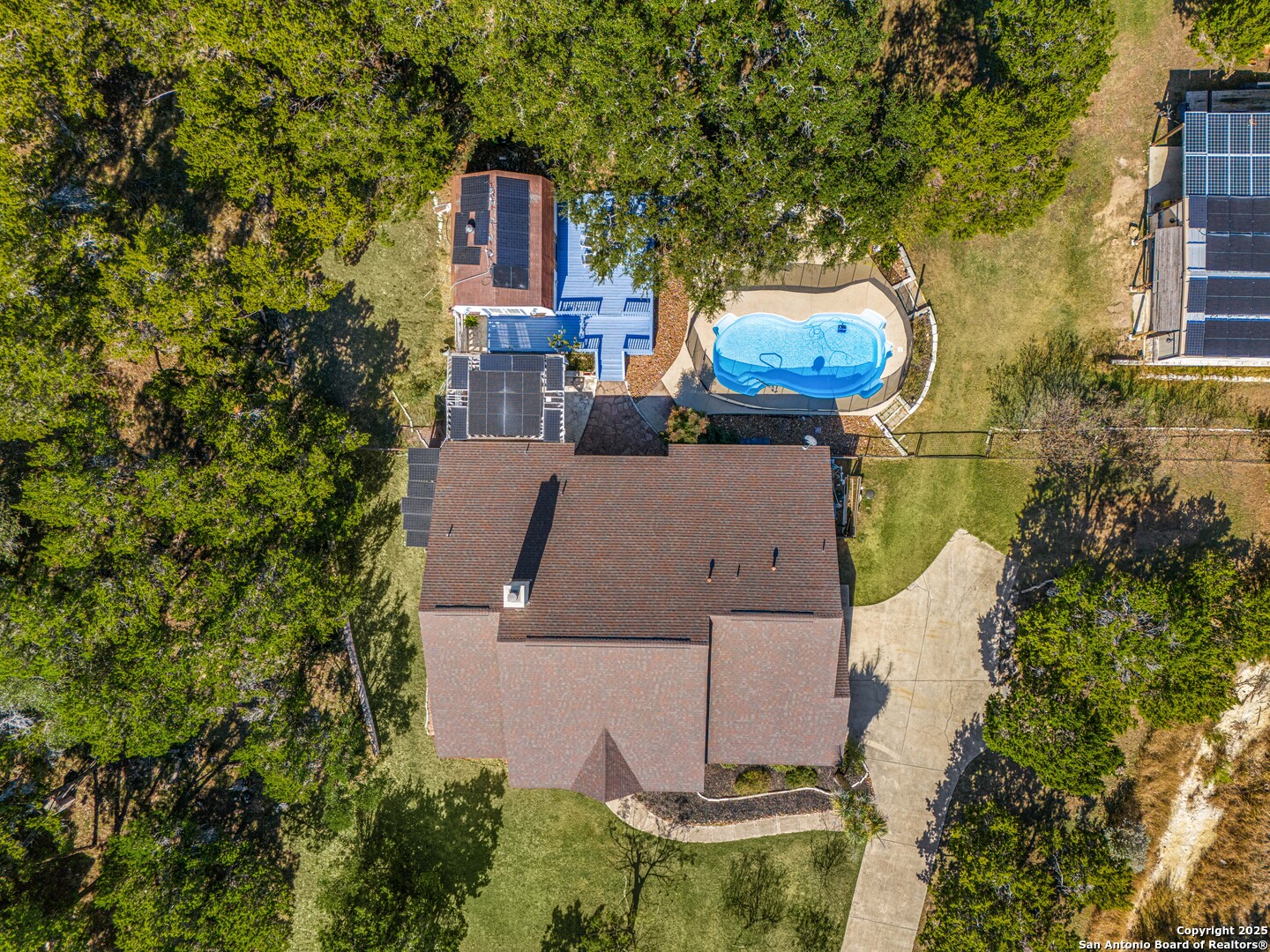 166 Bridle Path Spring Branch, TX 78070 - Photo 42 of 48 an aerial view of a house with swimming pool and garden space