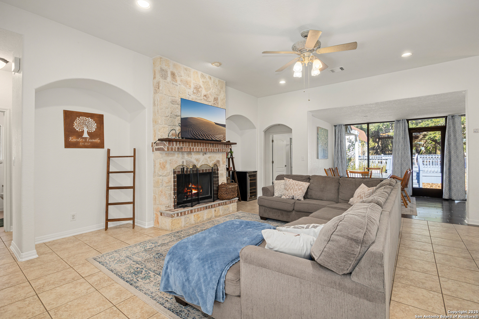 166 Bridle Path Spring Branch, TX 78070 - Photo 8 of 48 a living room with furniture a fireplace and a flat screen tv