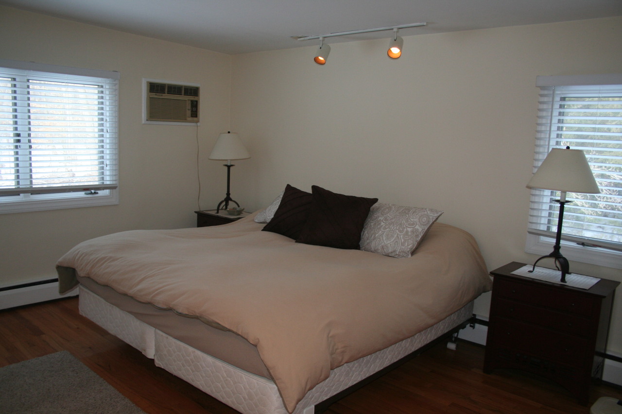 71 Silver Ridge Road New Canaan, CT 06840 - Photo 12 of 29 a bedroom with a bed and a lamp