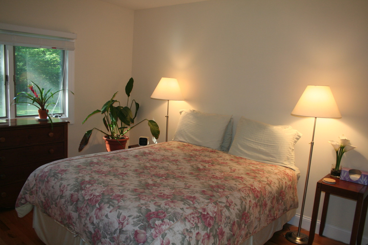 71 Silver Ridge Road New Canaan, CT 06840 - Photo 18 of 29 a bed sitting in a bedroom and a lamp next to a window