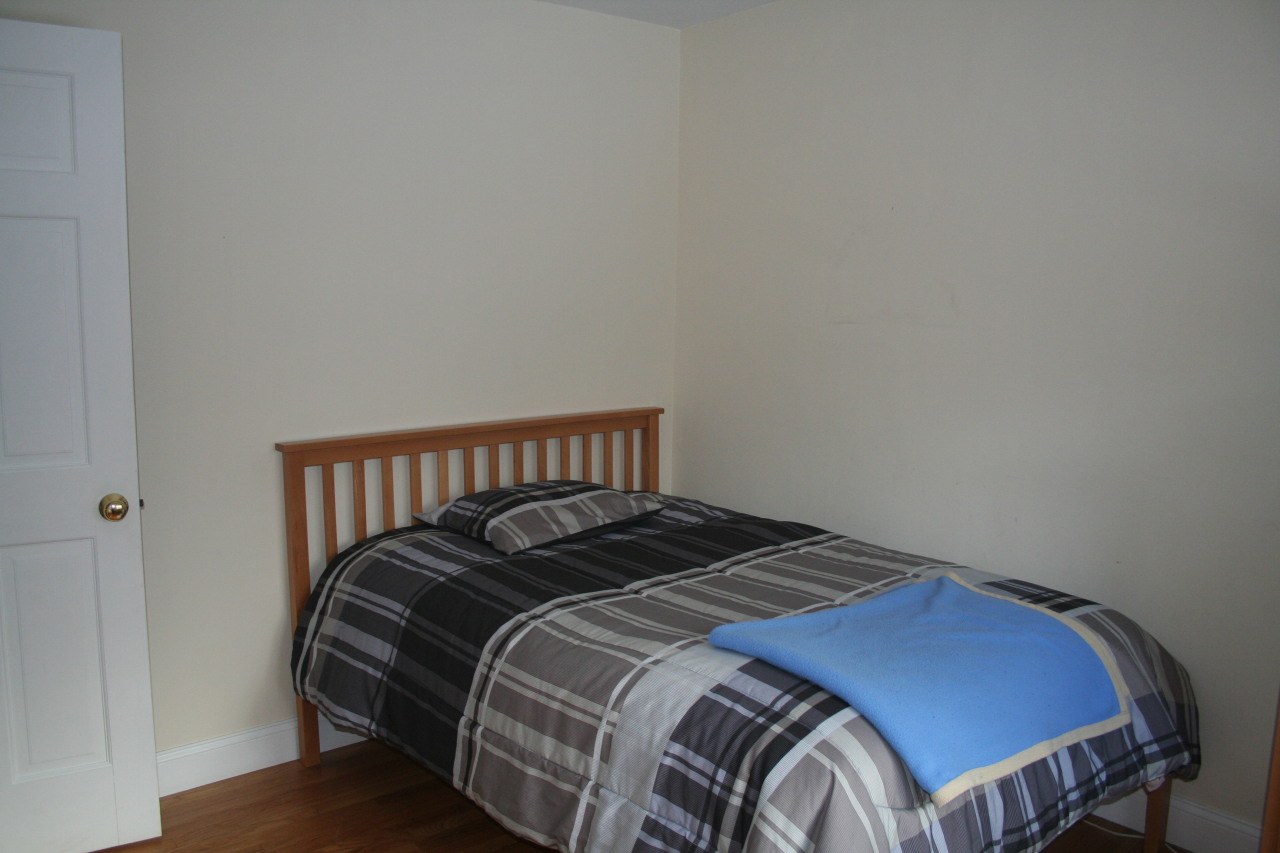 71 Silver Ridge Road New Canaan, CT 06840 - Photo 20 of 29 a bed sitting in a bedroom next to a window