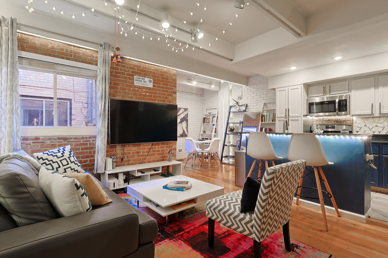1630 North Sedgwick Street, Unit 2 Chicago, IL 60614 - Photo 2 of 28 a living room with furniture kitchen view and a large window