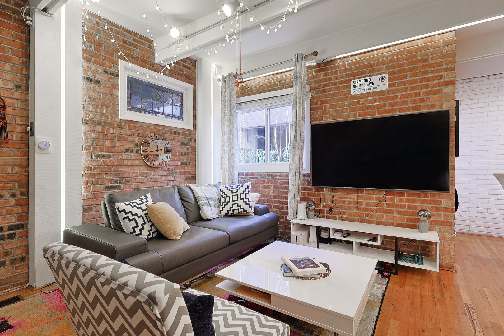 1630 North Sedgwick Street, Unit 2 Chicago, IL 60614 - Photo 3 of 28 a living room with furniture and a flat screen tv