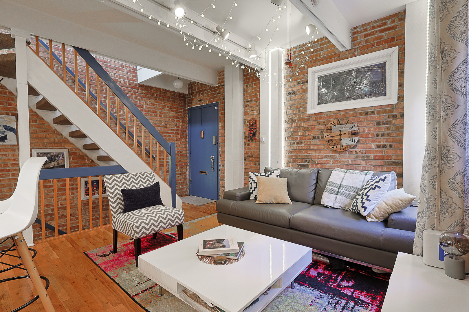 1630 North Sedgwick Street, Unit 2 Chicago, IL 60614 - Photo 4 of 28 a living room with furniture and a rug