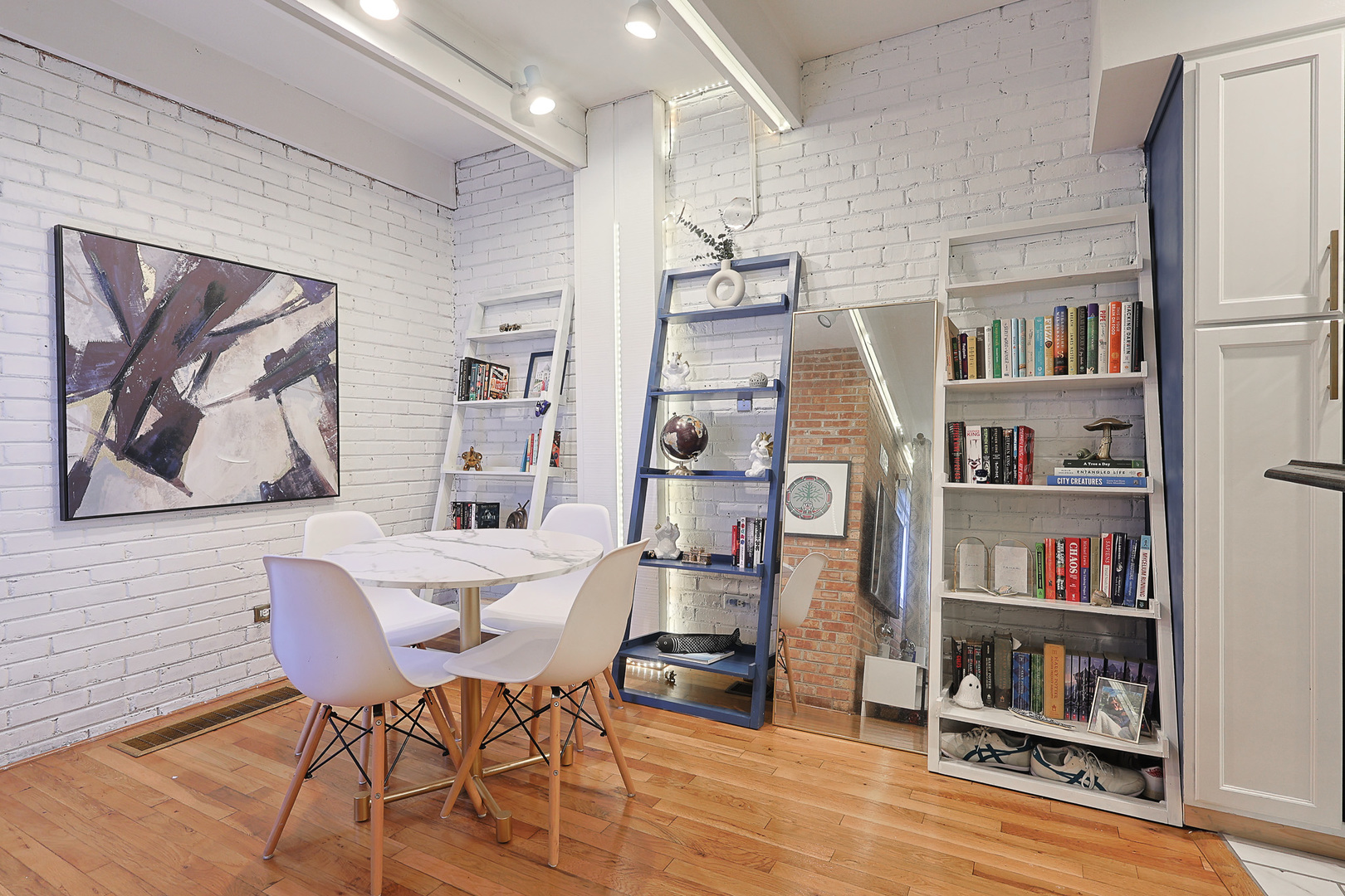 1630 North Sedgwick Street, Unit 2 Chicago, IL 60614 - Photo 8 of 28 a view of a dining room with furniture and a book shelf