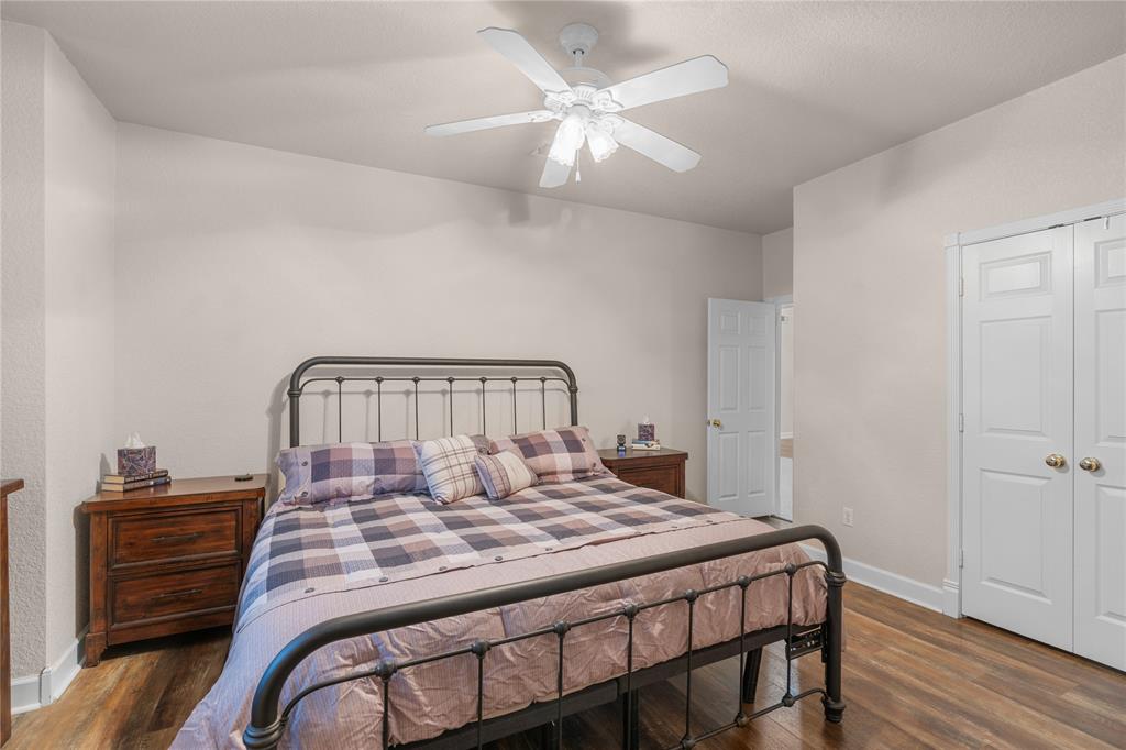 400 Indian Hills Road Gatesville, TX 76528 - Photo 28 of 38 a bedroom with a bed and a chandelier