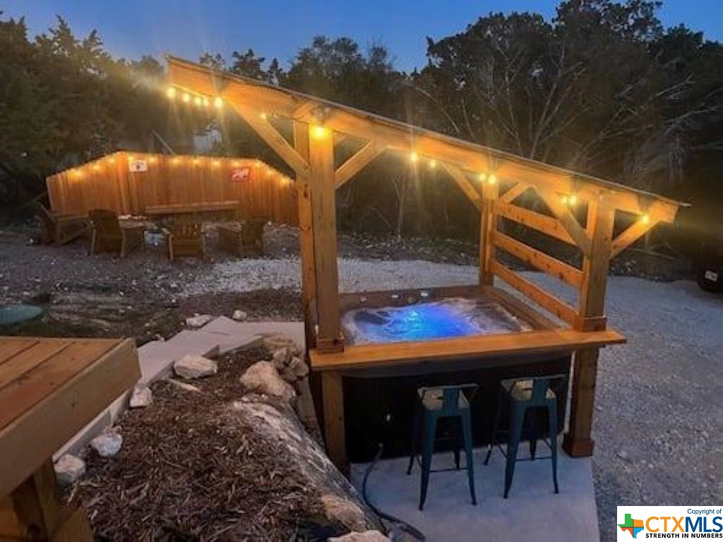 a view of a backyard with a patio and a fire pit