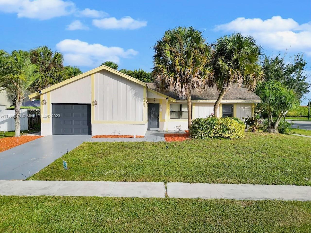 9883 Liberty Court Boca Raton, FL 33434 - Photo 1 of 29 a front view of a house with a yard
