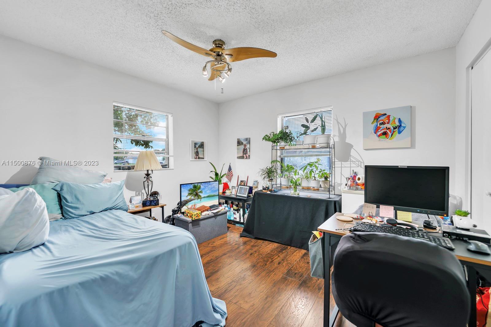 9883 Liberty Court Boca Raton, FL 33434 - Photo 8 of 29 a bedroom with furniture and a flat screen tv