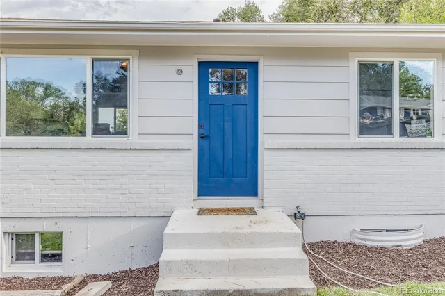 a bathroom with a toilet and a window