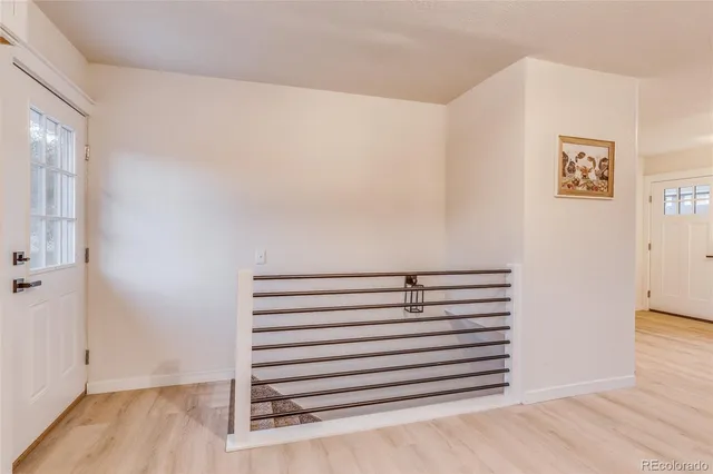 a view of a room with wooden floor
