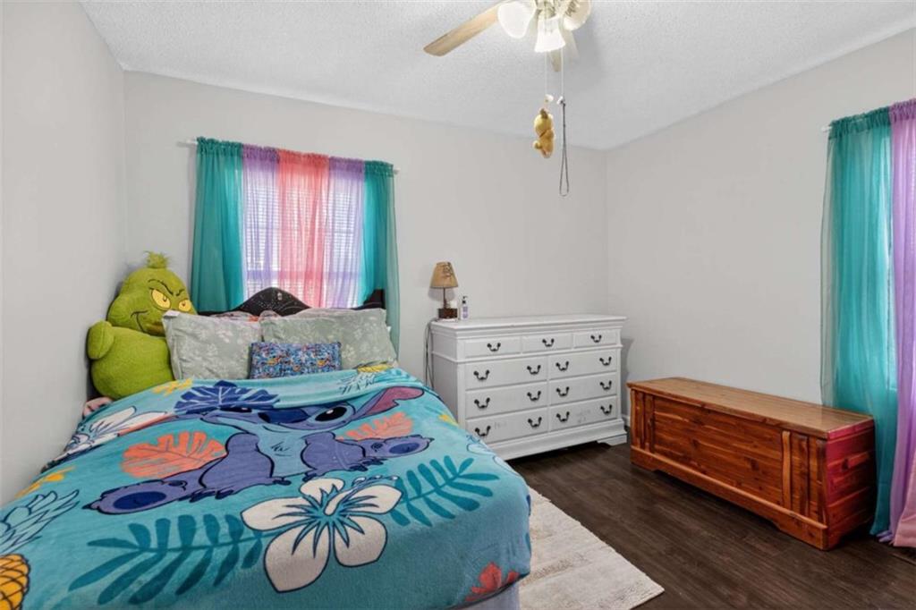 507 Grogan Road Buchanan, GA 30113 - Photo 14 of 31 a bedroom with two beds and a chandelier