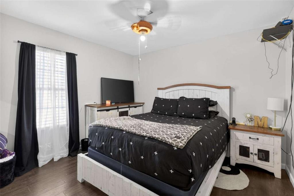 507 Grogan Road Buchanan, GA 30113 - Photo 16 of 31 a bedroom with a bed and a chandelier