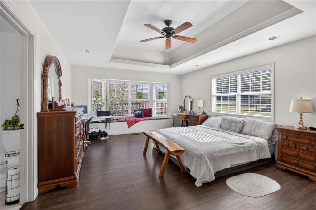 507 Grogan Road Buchanan, GA 30113 - Photo 22 of 31 a bedroom with a bed and a chandelier