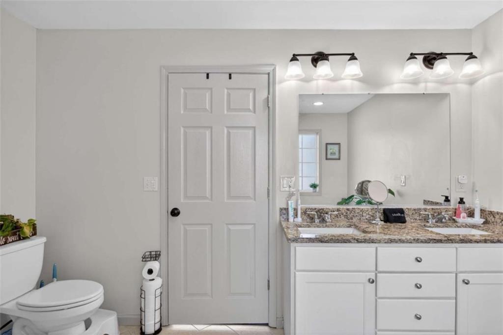 507 Grogan Road Buchanan, GA 30113 - Photo 24 of 31 a bathroom with a granite countertop sink a toilet and a mirror