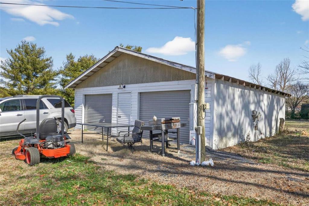 507 Grogan Road Buchanan, GA 30113 - Photo 29 of 31 a view of a backyard with table and chairs and a barbeque