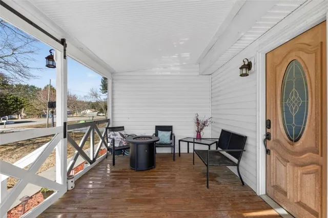 a view of a livingroom with furniture wooden floor and a rug