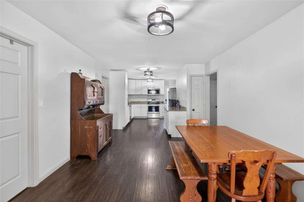 507 Grogan Road Buchanan, GA 30113 - Photo 9 of 31 a dining room with furniture and wooden floor