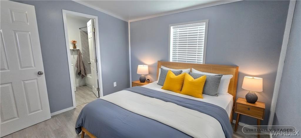 3675 Amado Road Golden Valley, AZ 86413 - Photo 11 of 35 a bedroom with a bed and wooden floor