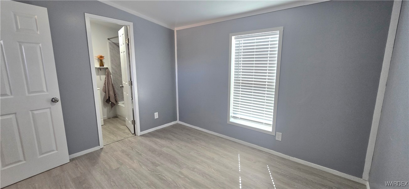 3675 Amado Road Golden Valley, AZ 86413 - Photo 12 of 35 an empty room with windows and closet