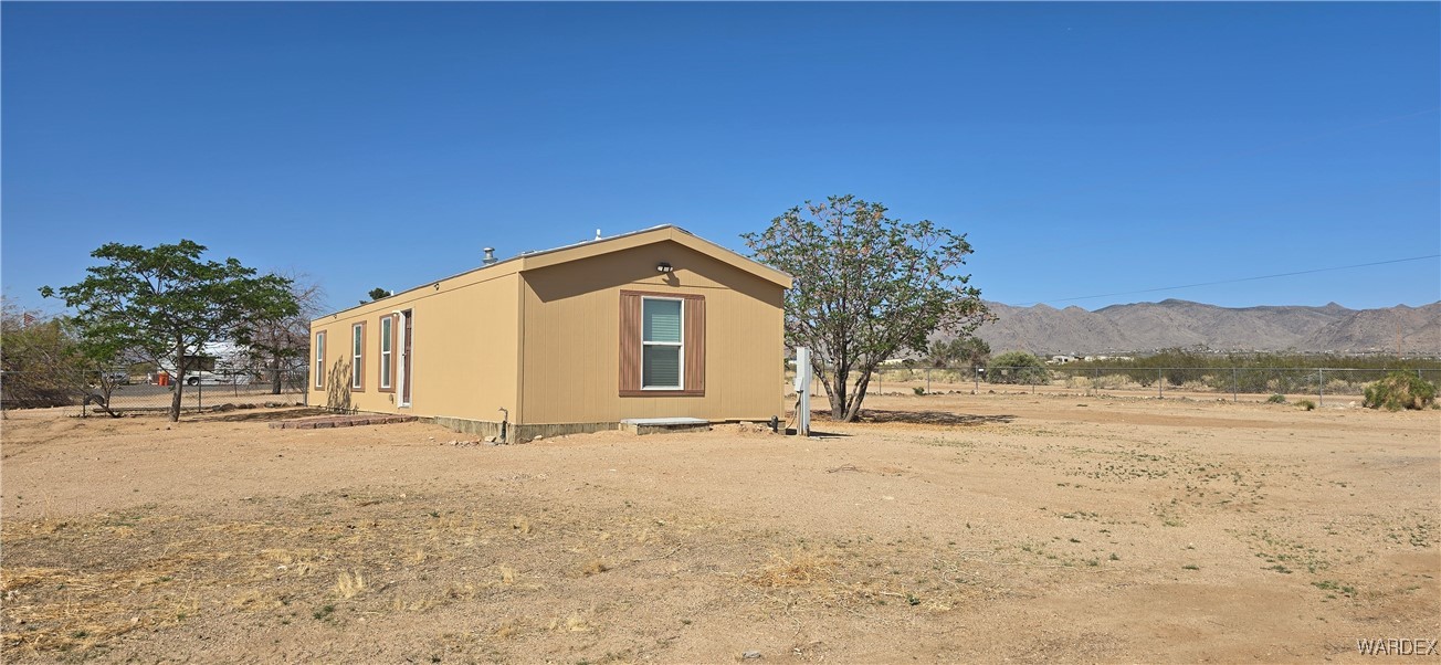 3675 Amado Road Golden Valley, AZ 86413 - Photo 34 of 35 a view of a house with a yard
