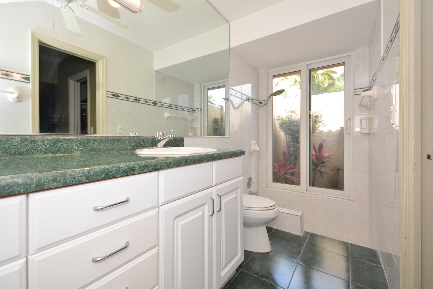 200 North Country Club Boulevard Boca Raton, FL 33487 - Photo 17 of 27 a bathroom with a granite countertop sink mirror vanity and toilet